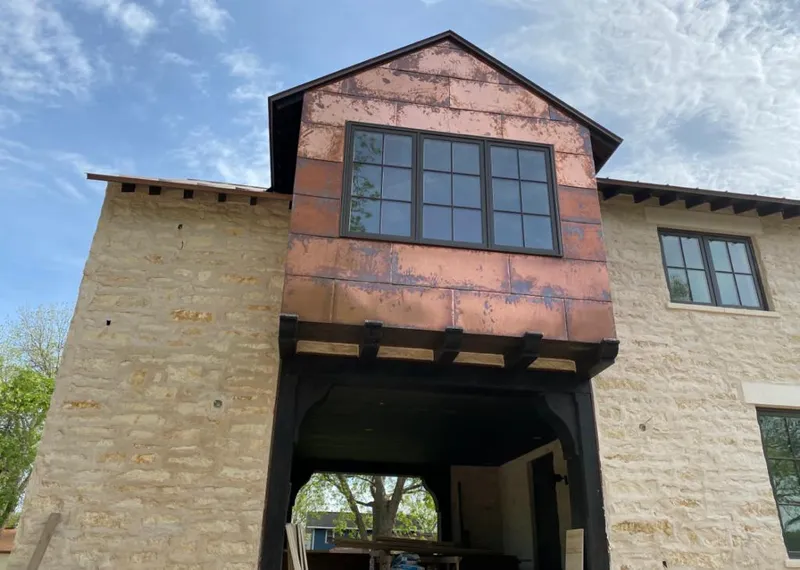 Copper metal panel facade on a stone building for Skylight Installation in Atlanta