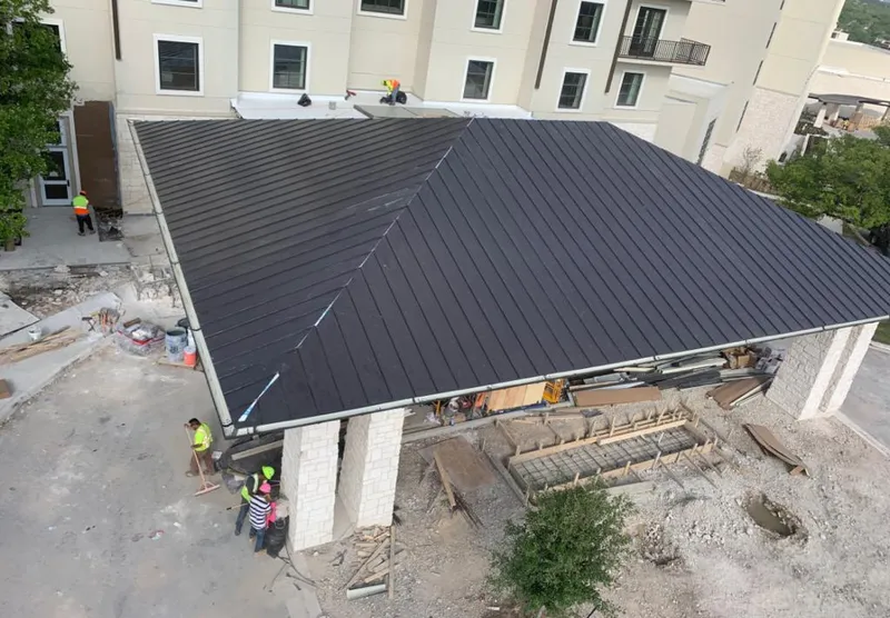 Metal roofing installation team working on a commercial building in Atlanta