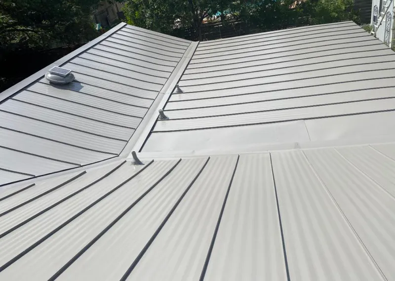 Solar attic fan installed on a metal roof for Roof Ventilation in Atlanta